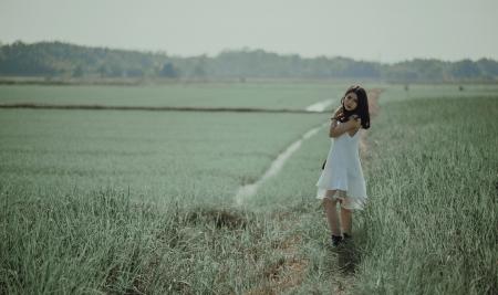 Woman in White Sleeveless Dress on Grass Field