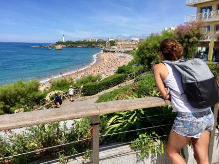 Woman In White Tank Top Leaning On Railing
