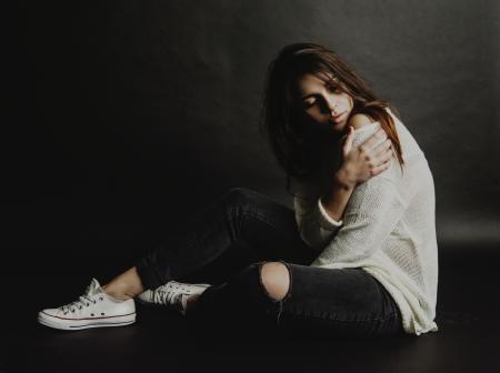 Woman in White Top and Black Distress Jeans