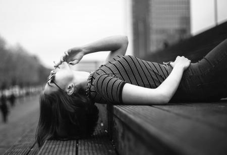 Woman Laying on Stairway Grayscale Photo