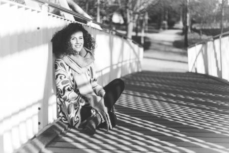 Woman Leaning Near White Metal Rail on Bridge