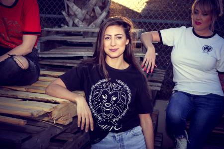 Woman Leaning on Brown Wooden Board Beside Woman Wearing White Crew-neck Shirt