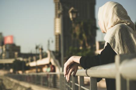 Woman Leaning on Hand Rails