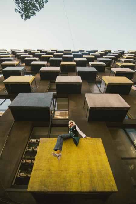 Woman On A Building Balcony