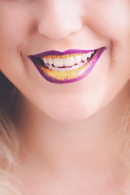 Woman Showing Her Purple and Yellow Lipsticks