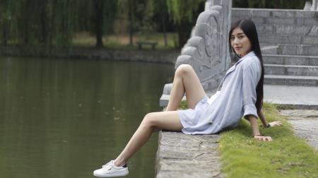 Woman Sitting beside a Lake