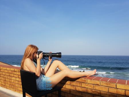 Woman Sitting Holding Dslr Camera