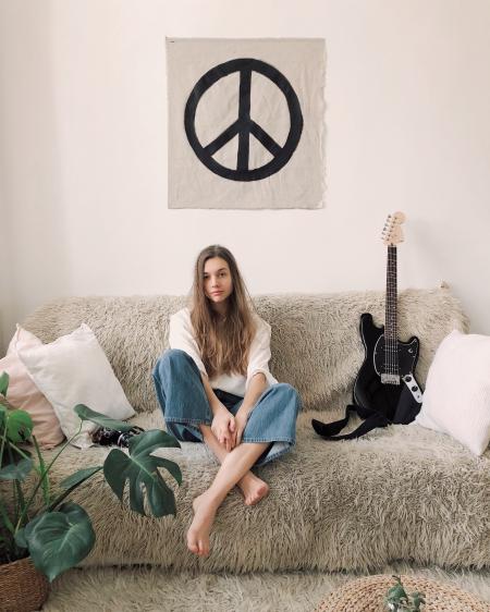 Woman Sitting in Grey Fur Sofa