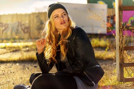 Woman Sitting Near Brown Wooden Plank