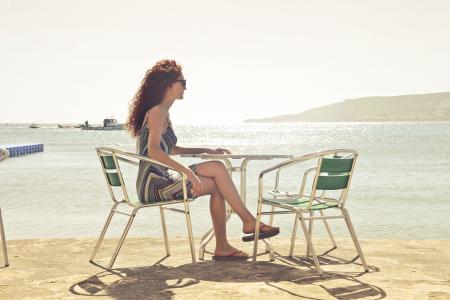 Woman Sitting on Armchair Near Seat