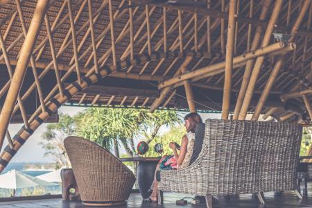 Woman Sitting On Brown Wicker Chair