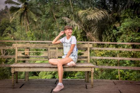 Woman Sitting on Brown Wooden Chair