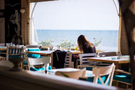 Woman Sitting on Chair With View of Sea