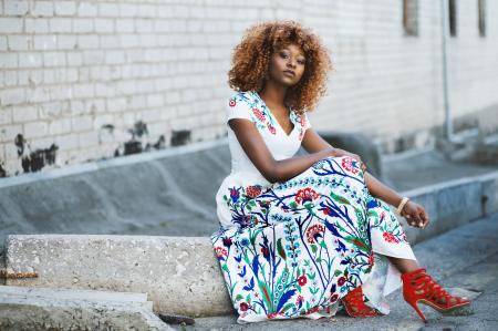 Woman Sitting on Concrete Block Wearing Red Strap Heels