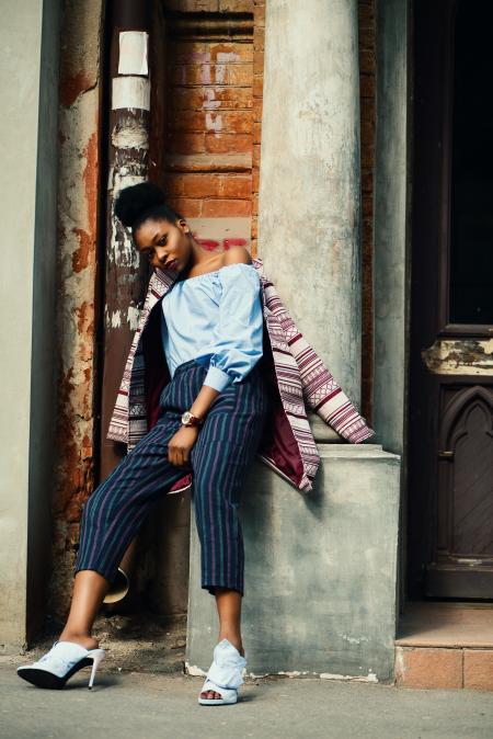 Woman Sitting on Concrete Column