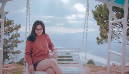 Woman Sitting on White Canopy Swing