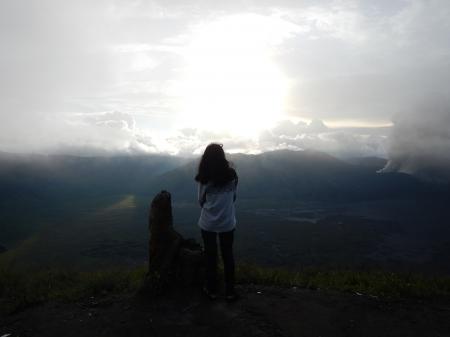 Woman Staing at the Edge of the Mountain Facing the Sun