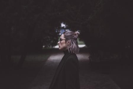 Woman Standing at the Middle of the Road Under Trees Lowlight Photography