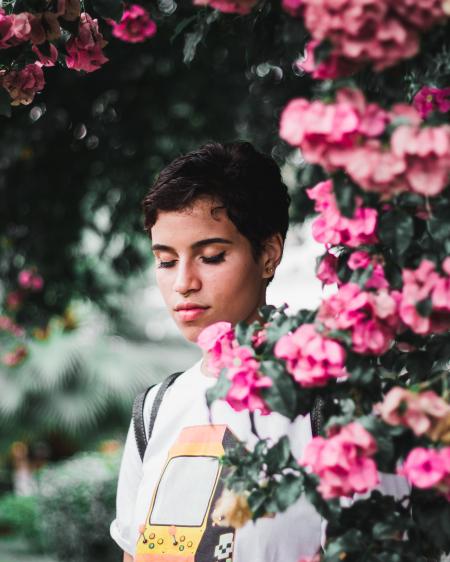 Woman Standing Beside Pink Petaled Flowers