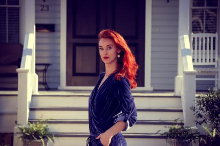 Woman Standing in Front of White Wooden House