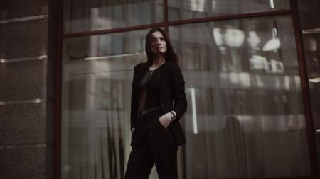 Woman Standing Near Clear Glass Window