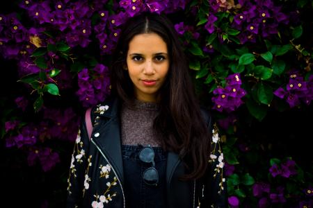 Woman Standing Near Purple Flowers