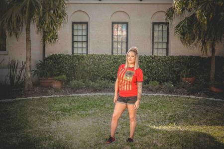 Woman Standing on Grass Field in Front of House