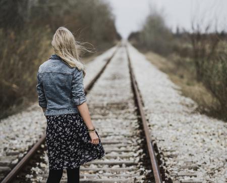 Woman Standing on Railroad