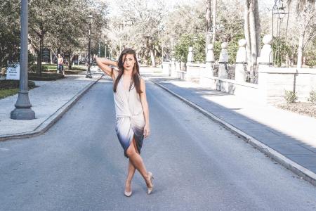 Woman Standing on Street With Cross Leg