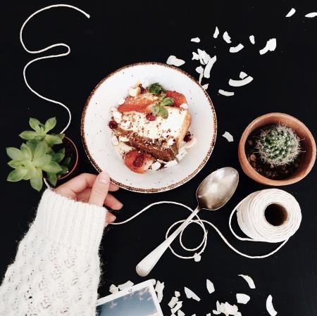 Woman Touching White and Brown Ceramic Saucer With Strawberry Cake