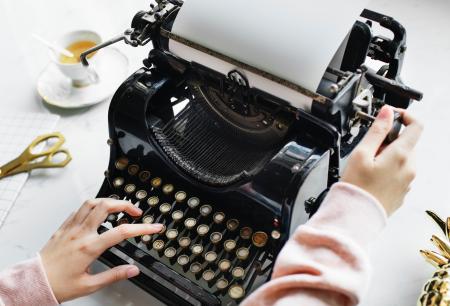 Woman Uses Black Typewriter