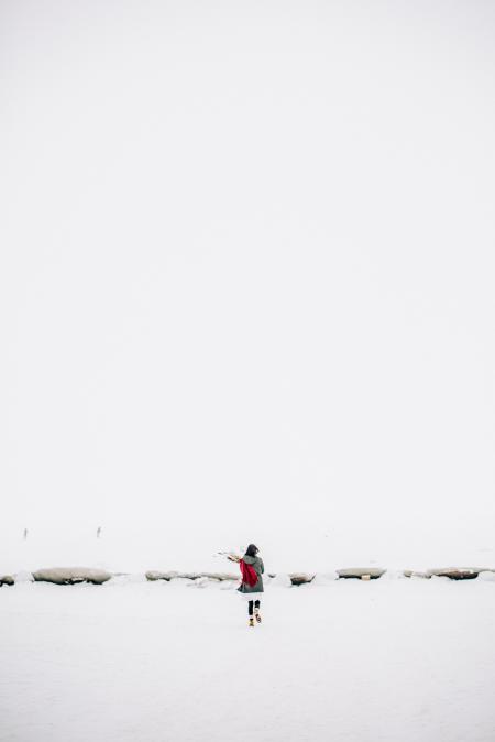 Woman Walking on Snow-covered Field