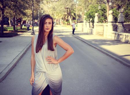 Woman Weairng White and Gray Sleeveless Dress Standing on Gray Road