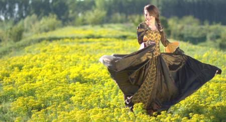 Woman Wearing Black and Brown Dress Standing on Green Grass during Daytime