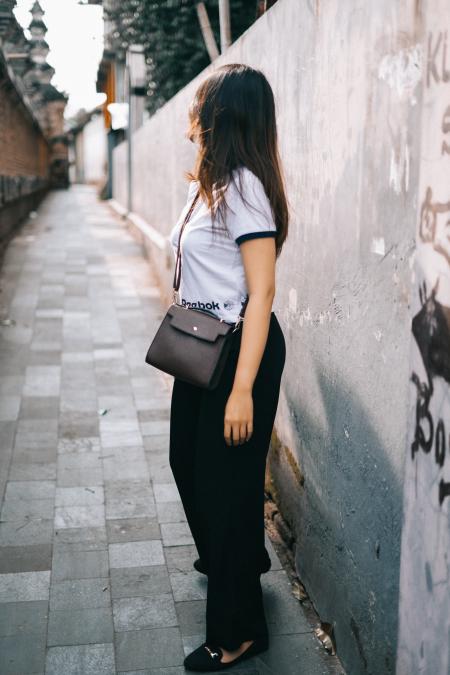 Woman Wearing Black and White T-shirt and Black Pants