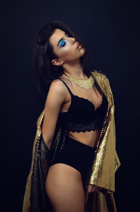 Woman Wearing Black Brassiere and Panty With Sequinned Gold-colored Coat Robe