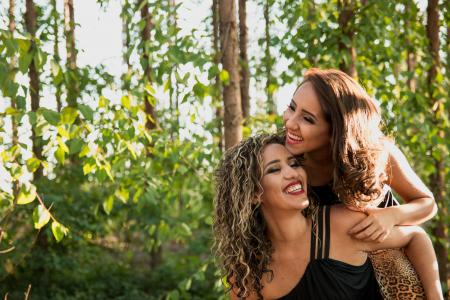 Woman Wearing Black Camisole Beside Woman in Black Dress