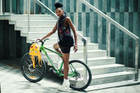 Woman Wearing Black Dress Riding Bicycle Near Stairs