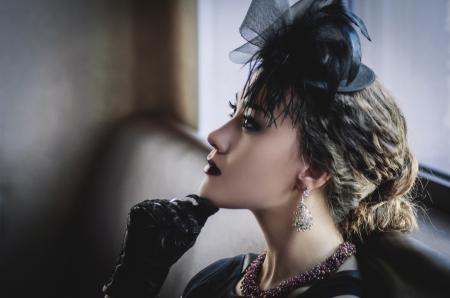 Woman Wearing Black Dress Sitting on Sofa