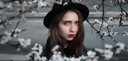 Woman Wearing Black Hat and Dress With Red Lipstick Near White Flowers Selective Focus Photography