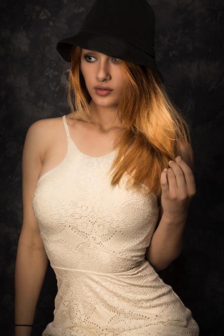 Woman Wearing Black Hat and White Sleeveless Dress