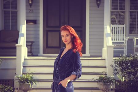 Woman Wearing Black Jumpsuit Standing Near the House