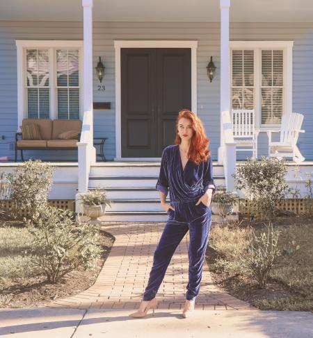 Woman Wearing Black Jumpsuit Standing Near the House