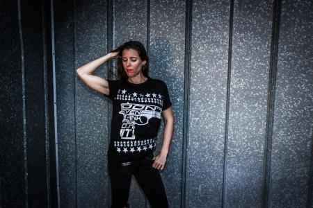 Woman Wearing Black Shirt and Pants Near Gray Wall