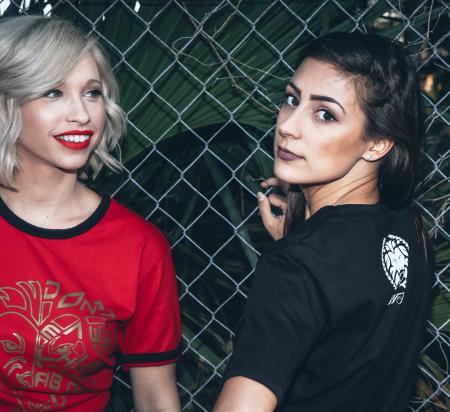 Woman Wearing Black Shirt Beside Woman Wearing Red Shirt