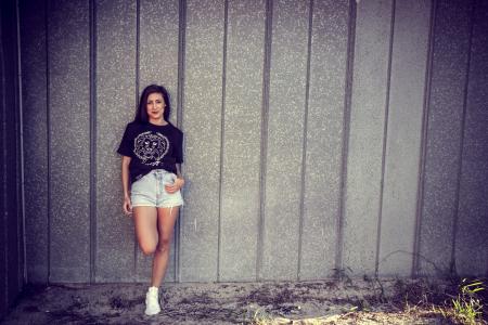Woman Wearing Black Shirt Leaning on Wall