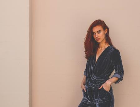 Woman Wearing Black Suede Top and Blue Bottoms