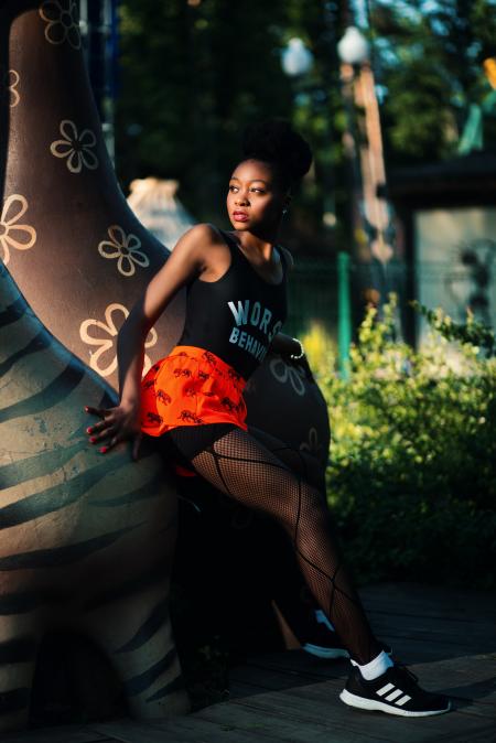 Woman Wearing Black Tank Top Near Brown Statue