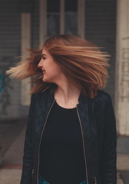 Woman Wearing Black Zip-up Jacket Looking Sideways