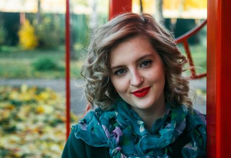 Woman Wearing Blue and Purple Floral Print Scarf Taking a Selfie